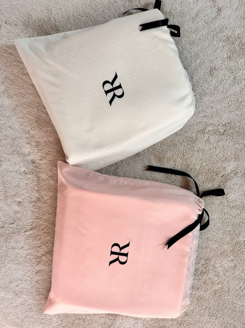Juego de sábanas Rosas Home en bolsas de jacquard marfil y rosa con monograma RR y cinta de satín negro